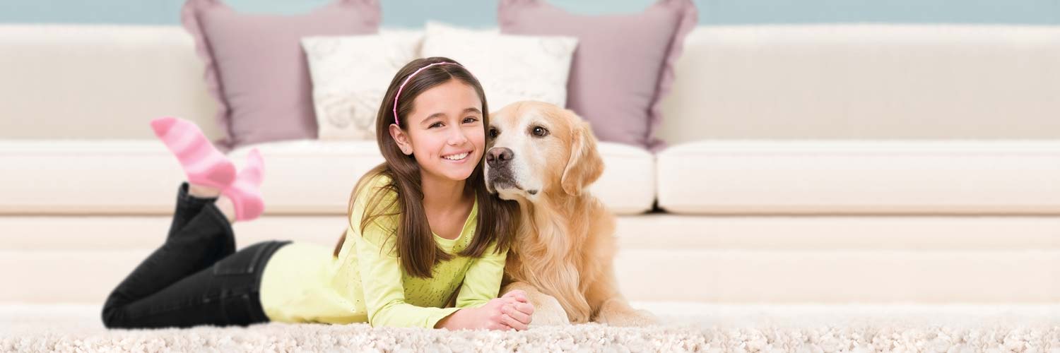 Girl with dog on carpet